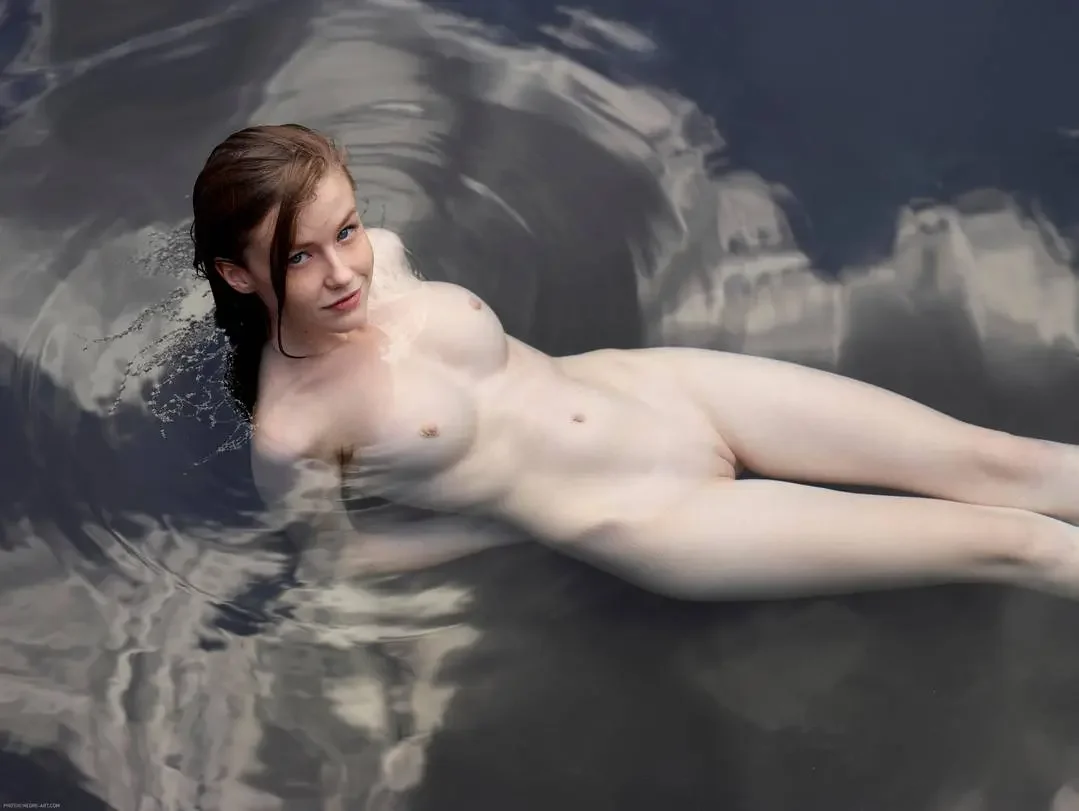 emily bloom, 1girl, female only, white female, breasts, nipples, looking at viewer, pussy, long hair, female, shaved pussy, front view, shaved, brown hair, completely nude, navel, medium breasts, straight hair, naked, dark hair, nude, pink nipples, smile, solo, outdoors, blue eyes, lips, water, lying down, ukrainian female, arms behind back, partially submerged
