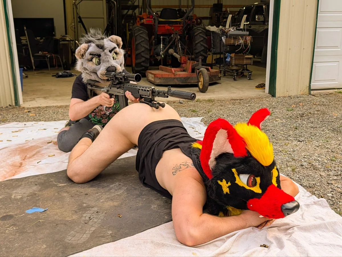 ass, partially dressed, tattoo, bottomless, on floor, outdoors, male, on knees, white male, male only, kneeling, side view, furry, socks, legs spread, shirt, black shirt, 2boys, male focus, anthro, ass up, holding, mask, weapon, gun, holding gun, holding weapon, rifle, scope