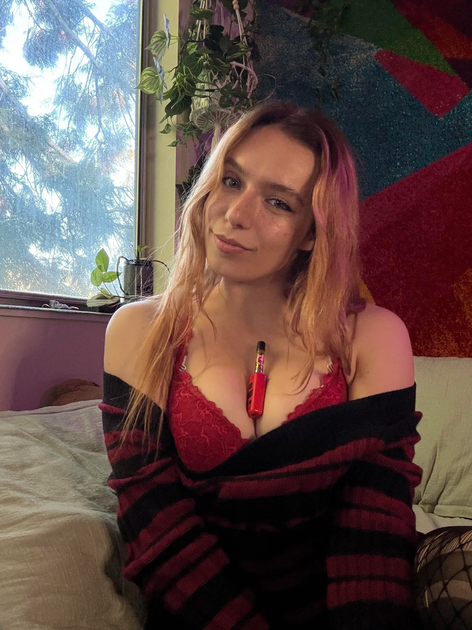 kittencases2, 1girl, female only, white female, breasts, looking at viewer, light-skinned female, long hair, front view, on bed, blonde hair, smile, reddit, non-nude, bra, blue eyes, cleavage, freckles, clothed, fishnet stockings, sweater, red bra, canadian female, sweater down, vape