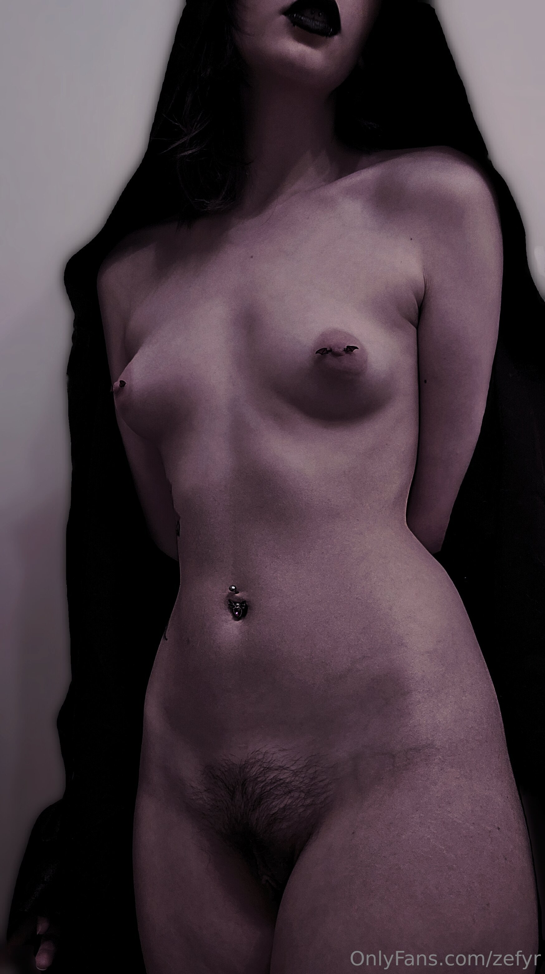 zefyr, 1girl, female only, white female, breasts, nipples, areolae, medium hair, piercing, standing, black hair, breasts apart, small breasts, stomach, tattoos, pale skin, watermark, pale, onlyfans, nipple piercing, pubic hair, midriff, navel piercing, hips, waist, black lipstick, puffy nipples, bush, arms behind back